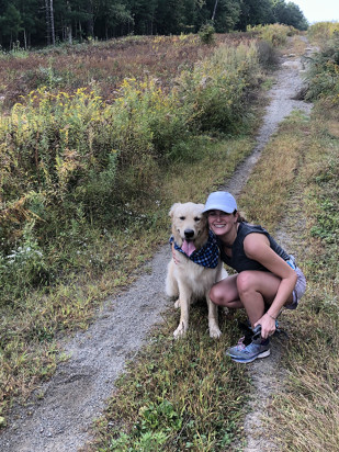 Lauren and her dog running on a trail