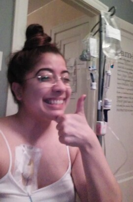 marieliz with a thumbs up while connected to her home ivs