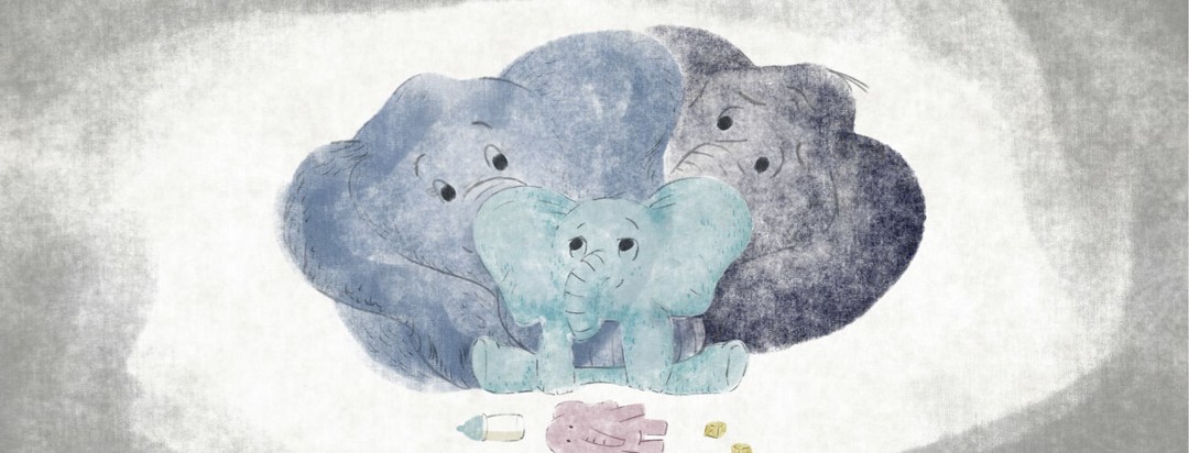 Two elephant parents holding a baby elephant lovingly with a toy elephant and blocks in the foreground