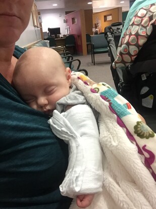 meagan holding her daughter margo as they wait for her sweat test